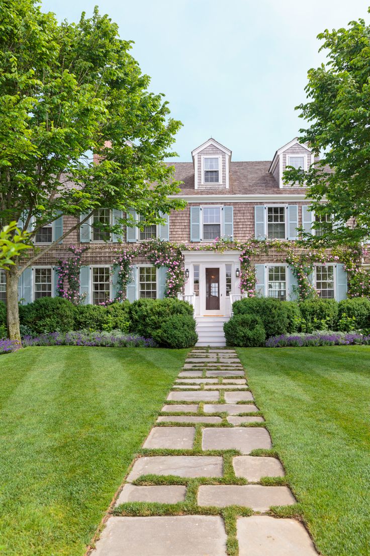 a large brick house with white trim and blue shutters is featured in the front cover of this magazine