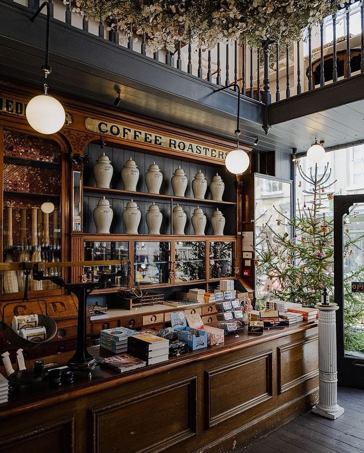 an old fashioned coffee shop with many vases on the shelves and plants hanging from the ceiling