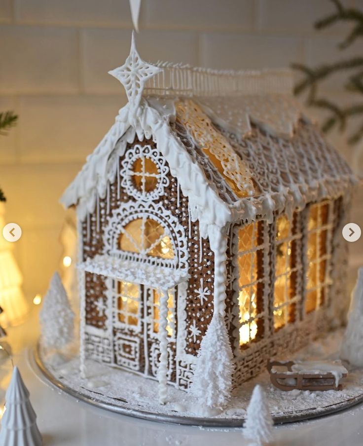 a gingerbread house is lit up for christmas