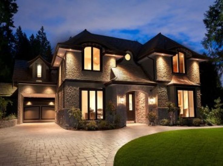 a large house lit up at night in the evening