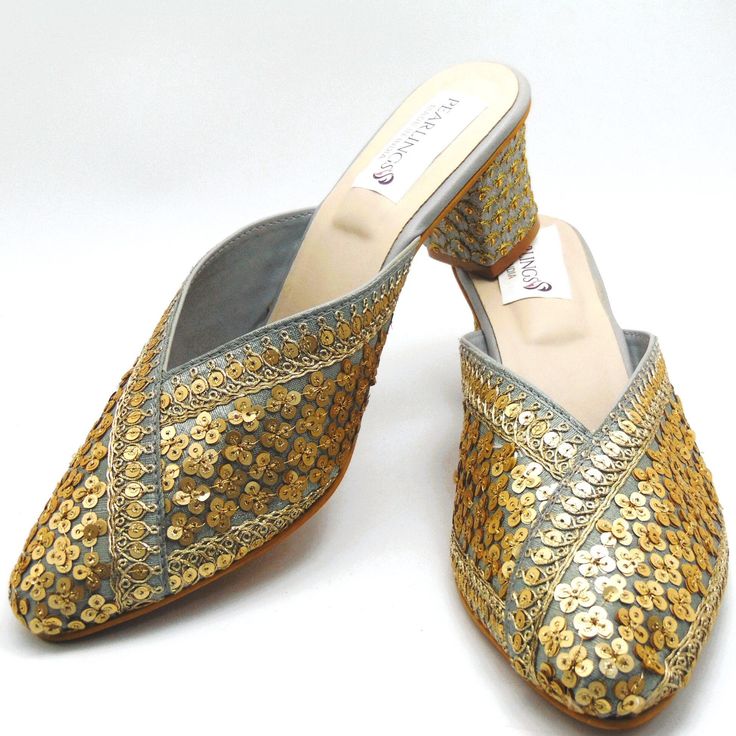 Check out our new collection of designer wedding shoes which we offer for you. These beautiful shoes are gray with gold sequins work on embroidered all around the shoe and round front shaped. These are extremely comfortable wedding shoes with a low heel these are comfortable to wear for long hours. These are perfect for your wedding or a formal event. These bridal shoes offer a heel size of 3 Inches. Don't miss out on these beauties! See our page for more of our collection! We ship out in a timely matter, wrapped in care for a safe secure trip to your location. Thank you for supporting our small business! Shipped from USA. Sizes available US 6,7,8,9,10. Party Heels With Round Toe And Slip-on Fit, Gold Slip-on Heels For Wedding, Gold Heels For Spring Wedding Guest, Gold Heels For Wedding Guest In Spring, Summer Party Slip-on Wedding Shoes, Summer Wedding Party Slip-on Shoes, Gold Slip-on Heels For Formal Occasions, Gold Slip-on Heels For Evening, Open Toe Sequin Wedding Heels