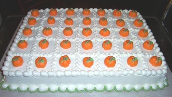 a cake with white frosting and orange candies on it