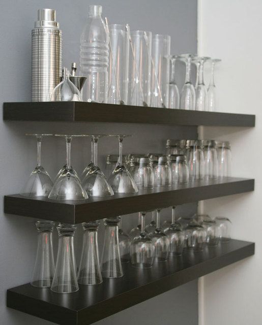 a shelf filled with lots of glasses and bottles