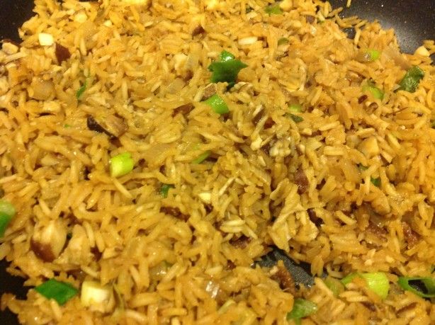 rice and vegetables being cooked in a wok