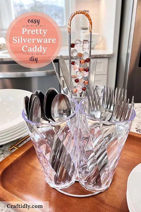 there is a glass dish with silverware in it