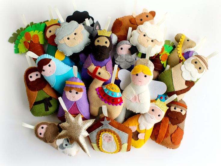 a bunch of small felt toys sitting on top of each other