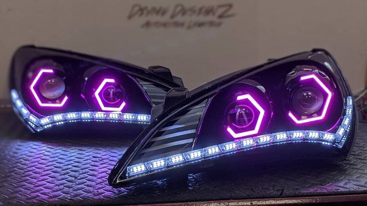 two headlights are shown with purple lights on them