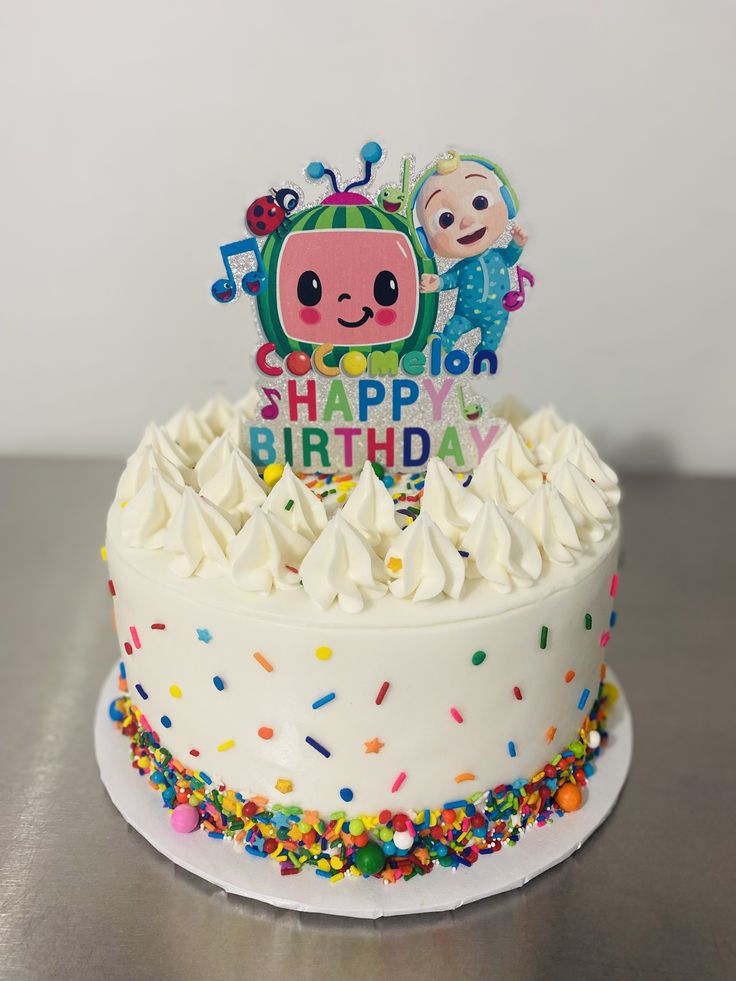 a birthday cake with sprinkles and an image of a cartoon character on top