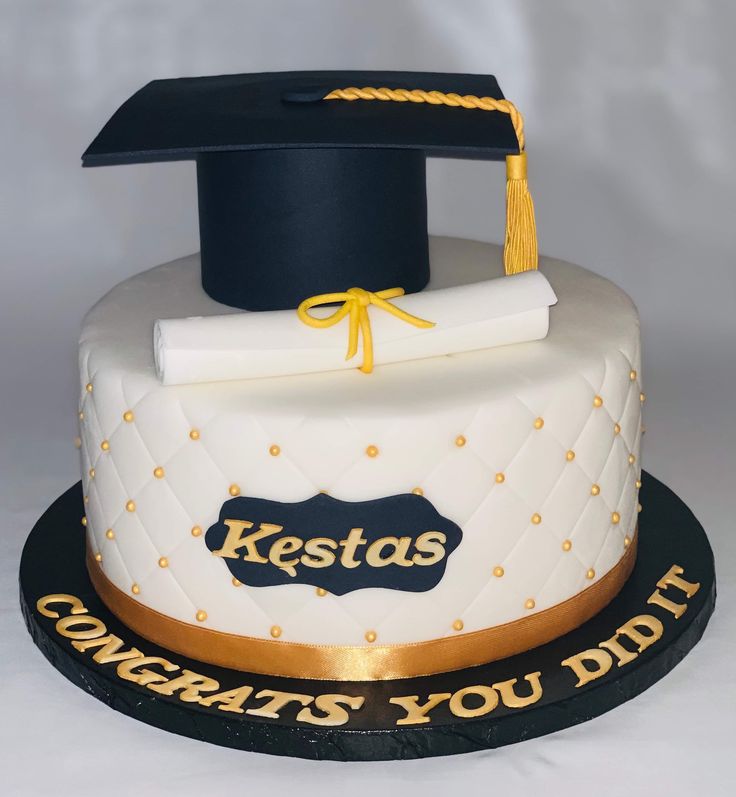 a cake with a graduation cap and diploma on top