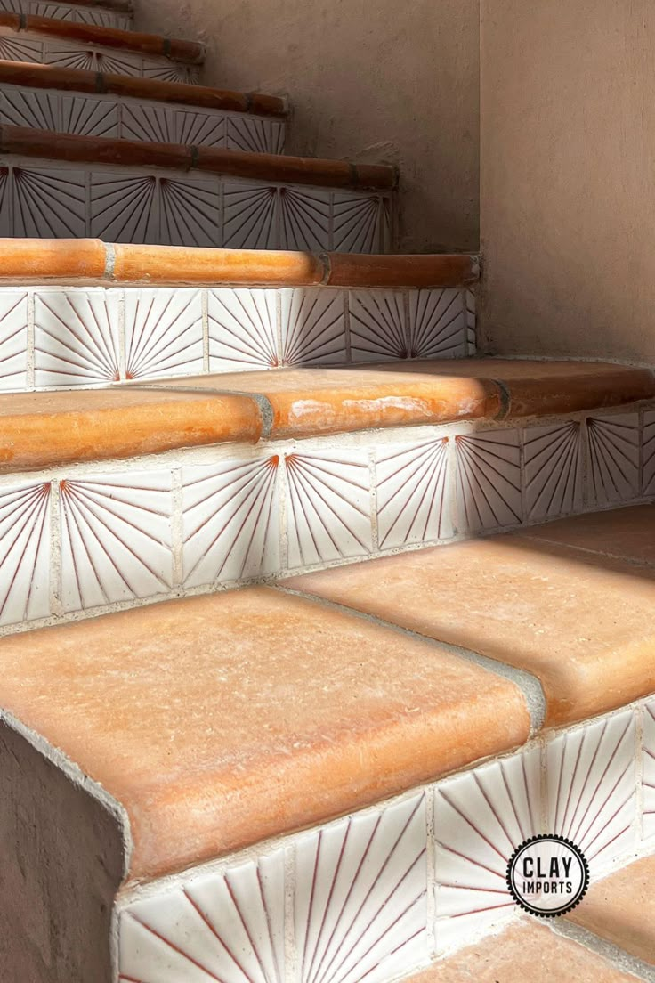 an image of some steps that have been painted with white and orange tiles on them