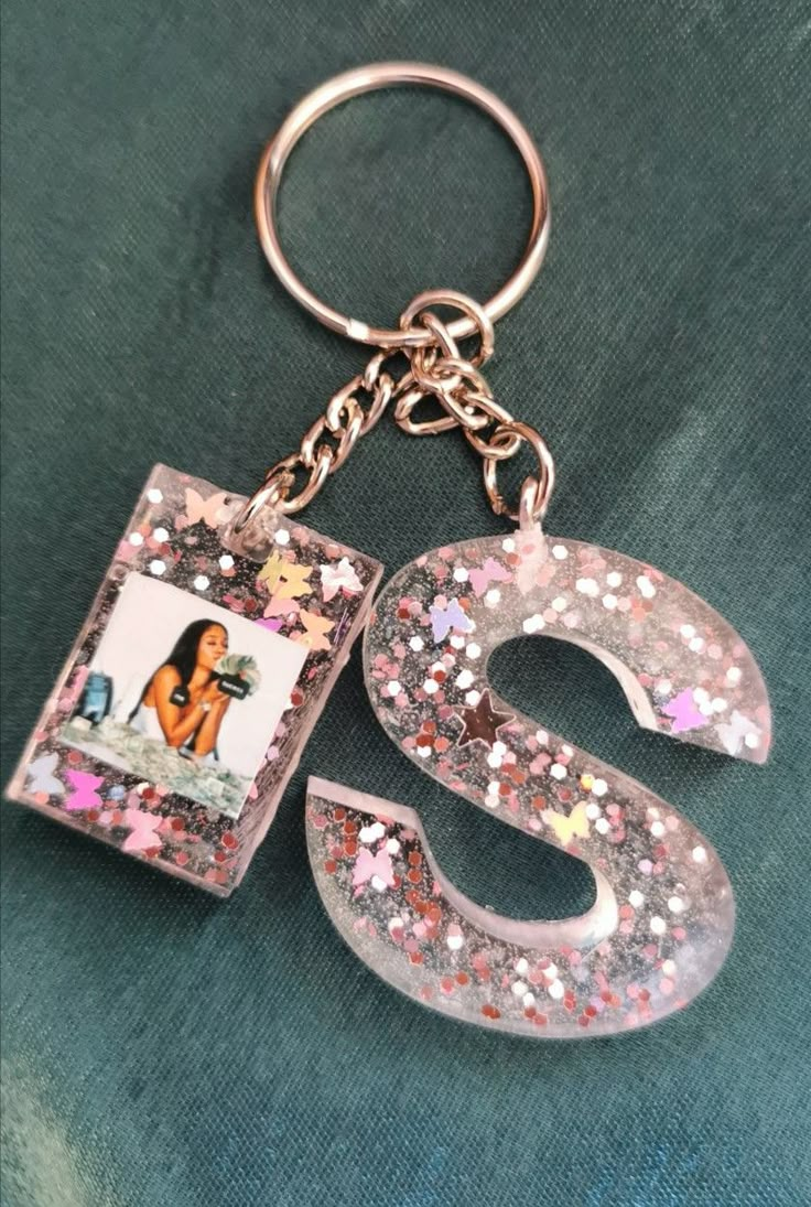 the letter s is made out of glitter and has an image of a woman on it