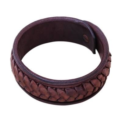 Designed by Thai artisan Khun Boom this striking bracelet circles the wrist with a wristband of dark brown leather. Khun Boom hand-weaves lighter brown leather strips around the exterior of the bracelet for a bold accessory. Brown Leather Strap Bracelet, Brown Leather Bracelet With Wrist Strap, Brown Leather Braided Bracelet As Gift, Adjustable Vintage Brown Leather Jewelry, Artisan Leather Bracelet With Leather Strap, Artisan Leather Strap Bracelet, Handmade Vintage Brown Braided Bracelets, Adjustable Brown Leather Bracelet With Wrist Strap, Handmade Distressed Brown Adjustable Bracelet