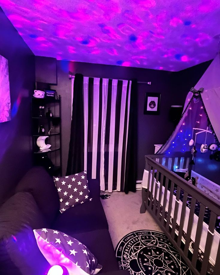 a baby's room decorated in purple and black with stars on the ceiling, striped curtains, and american flag pillows