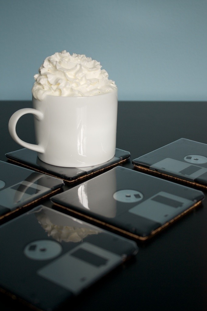 a coffee cup filled with marsh on top of coasters