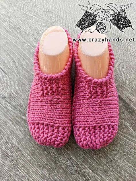 a pair of pink knitted slippers sitting on top of a wooden floor