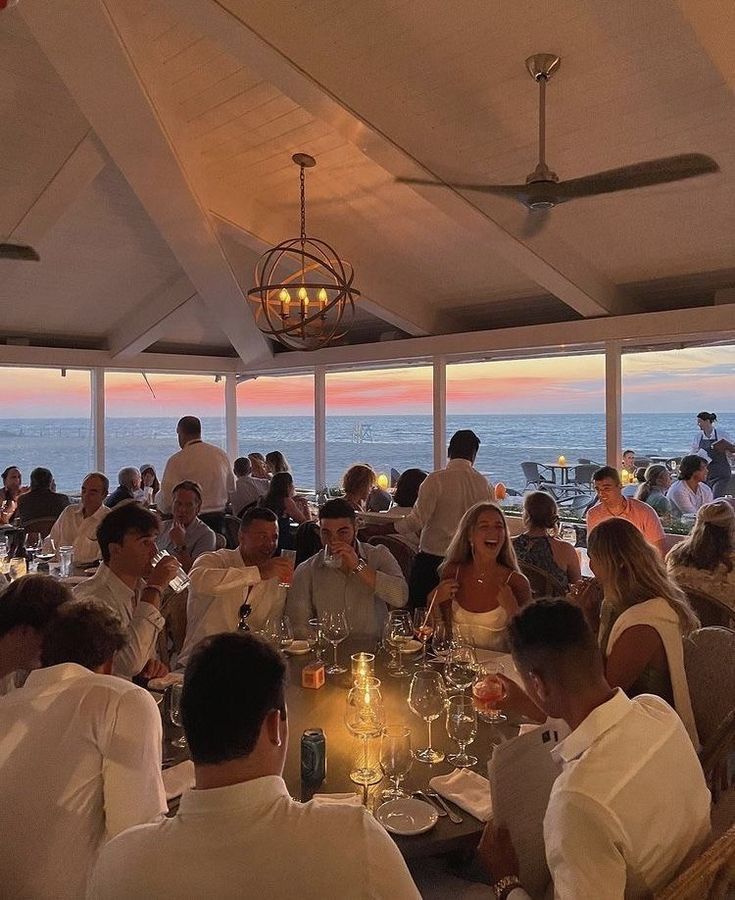 a group of people sitting around a dinner table