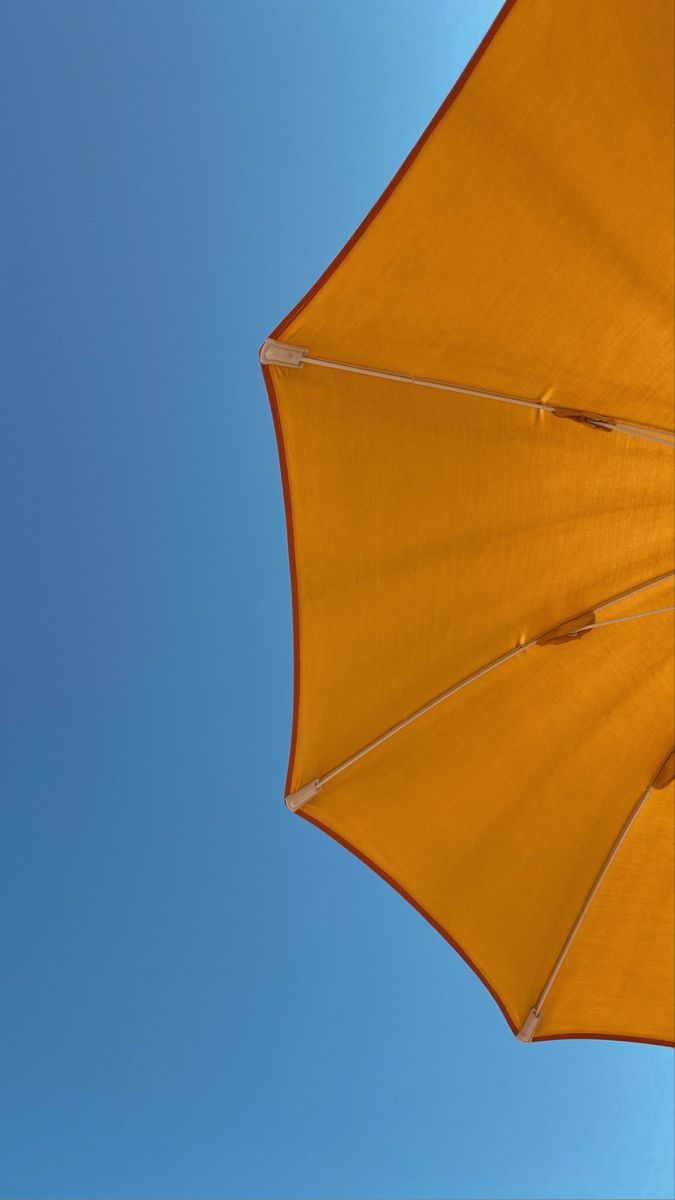 an open umbrella against a blue sky