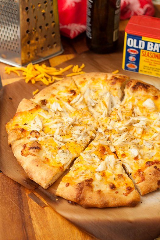 a pizza sitting on top of a wooden cutting board