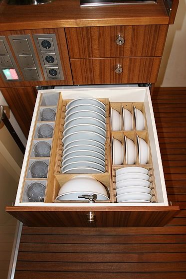 an open drawer with dishes in it