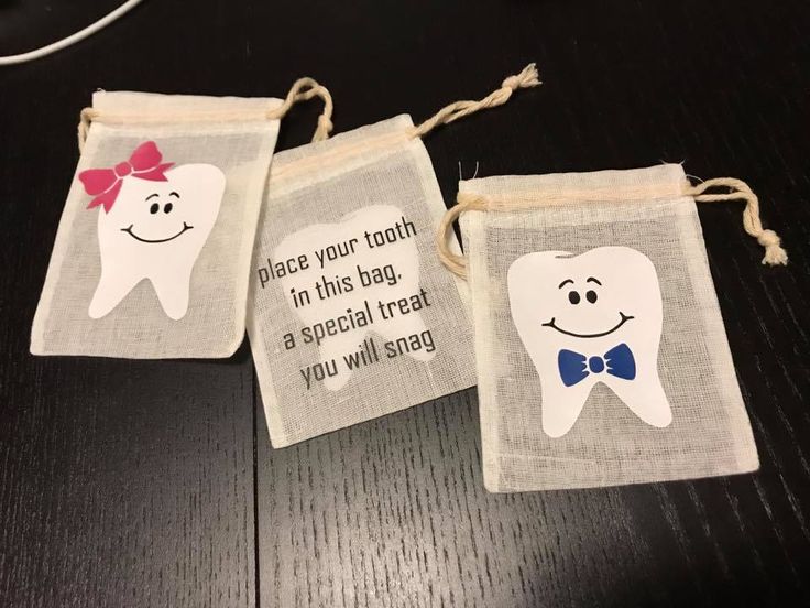 three small bags with tooth designs on them, one has a bow tie and the other has a message