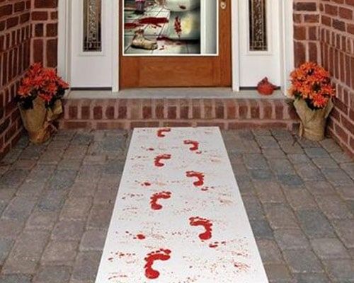 a white rug sitting on top of a brick floor next to a doorway with flowers