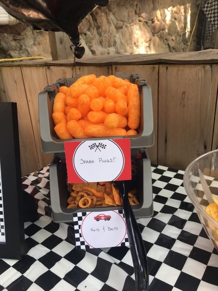 a table topped with lots of food on top of a black and white checkered table cloth