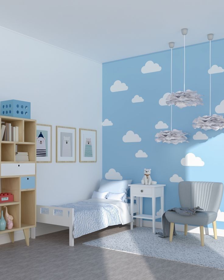 a child's bedroom decorated in blue and white with clouds painted on the wall