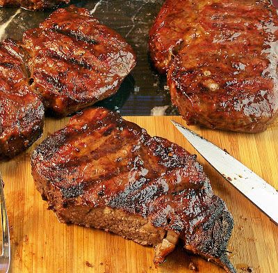 the steaks are ready to be grilled and served on the grill with a knife