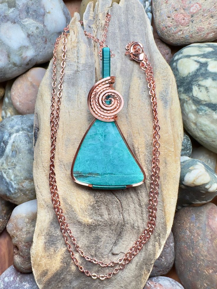 "Gem silica with copper and pacific blue wire wrap Comes with 18\" sterling silver plated chain shown in photos. Pendant measures 1-13/16\" x 15/16\"" Turquoise Necklace With Copper Wire, Blue Copper Pendant Necklace, Turquoise Copper Wire Necklace Gift, Turquoise Copper Wire Necklace As Gift, Turquoise Copper Wire Necklace For Gift, Wire Wrapped Turquoise Pendant Necklace, Blue Copper Wire Pendant Necklace, Blue Copper Wire Wrapped Necklaces, Blue Copper Wire Wrapped Necklace