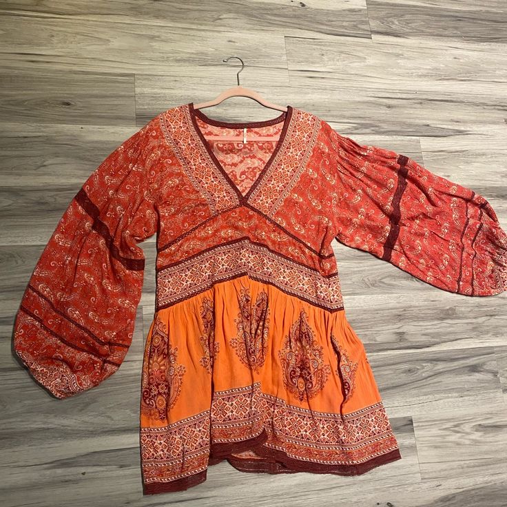 Free People Dress Never Worn Casual Boho Dress In Rayon For Fall, Fall Rayon Boho Dress With V-neck, Fall V-neck Boho Dress In Rayon, Fall Boho V-neck Dress In Rayon, Bohemian Red V-neck Mini Dress, Red Bohemian V-neck Mini Dress, Casual Red Long Sleeve Tunic, Orange Long Sleeve Boho Dress With Print, Red Fitted Tunic Dress