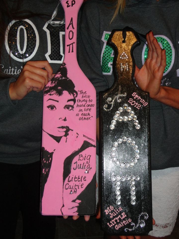 two girls are holding up skateboards decorated with swaroons and sequins