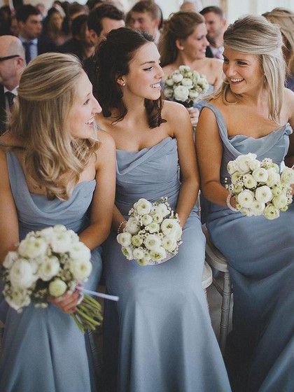 the bridesmaids are all dressed in blue dresses and bouquets for their wedding