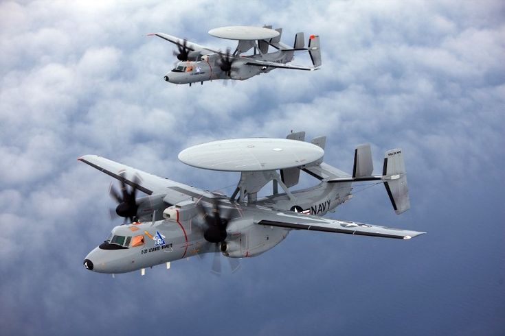 two planes flying in the air with propellers on their wings, and one is upside down