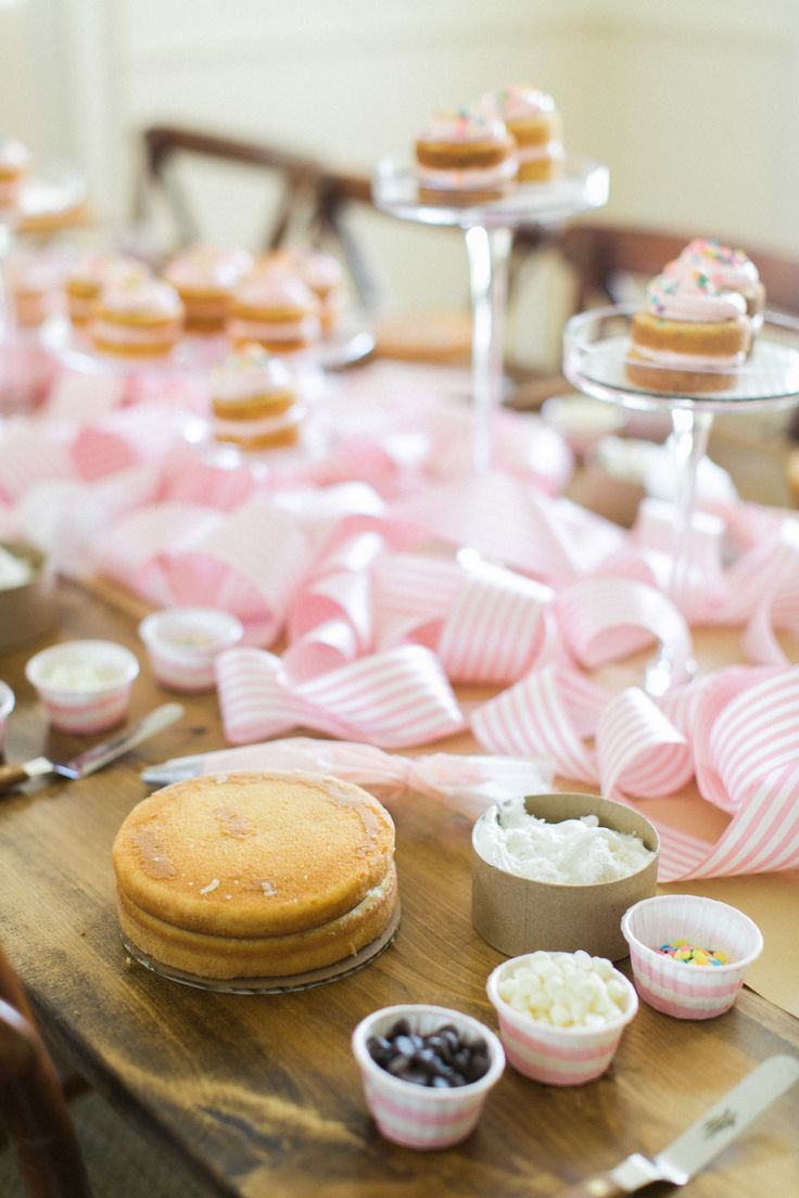 a table topped with lots of cupcakes and other desserts on top of it