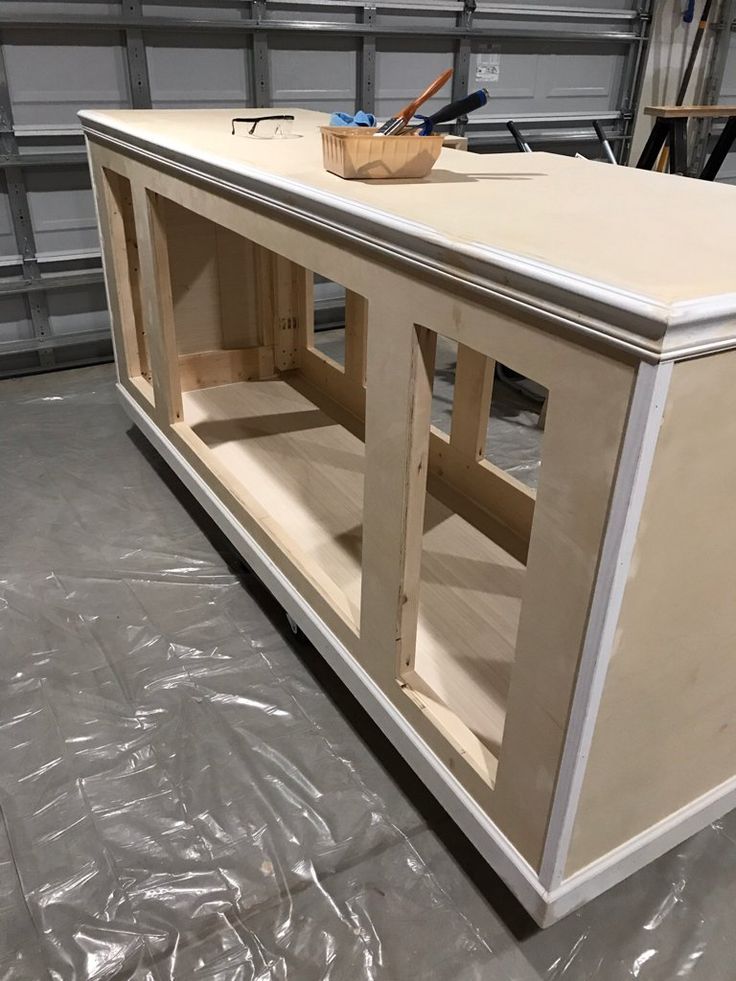 an unfinished entertainment center in a garage