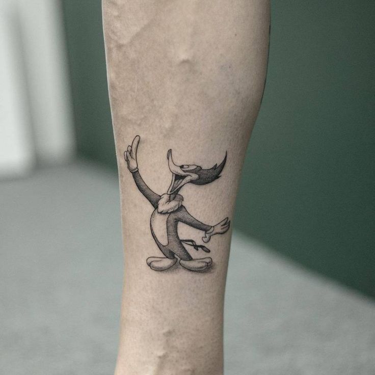 a tattoo on the leg of a person with an animal design on it's foot