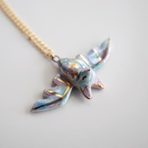 a necklace with a bird design on it