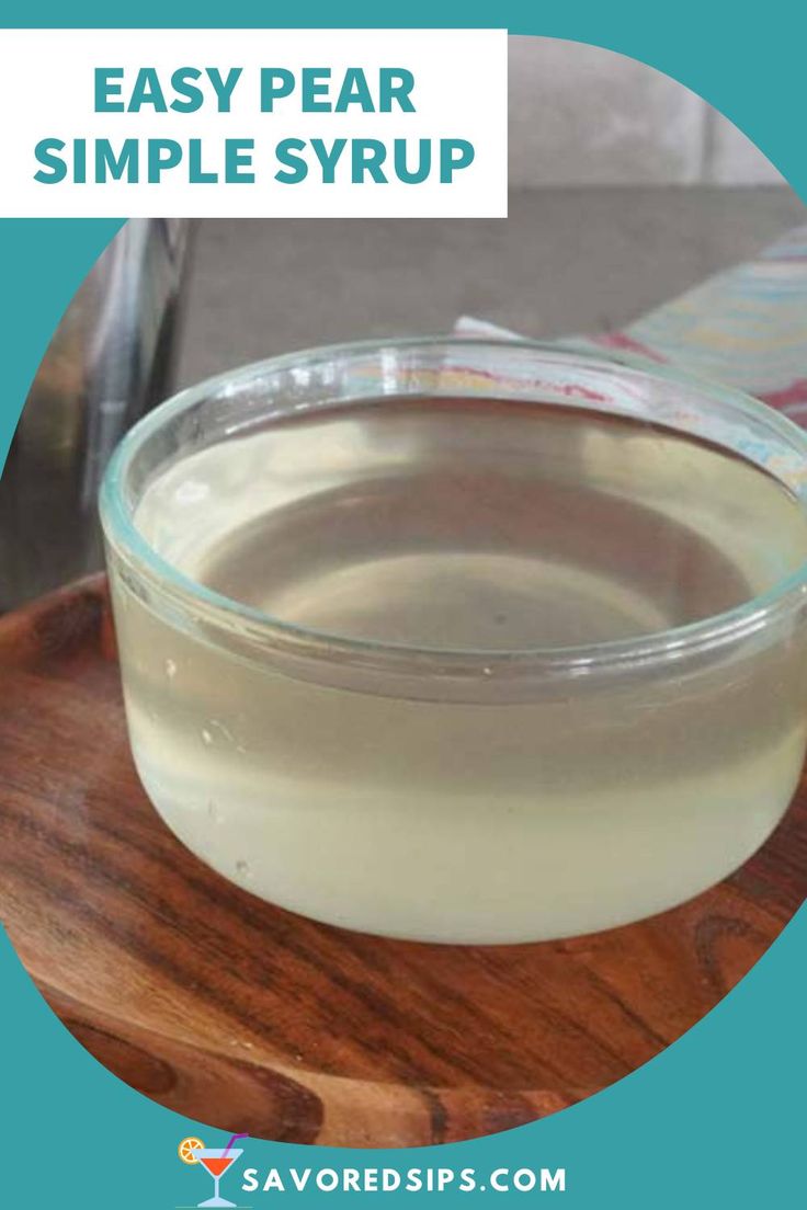 a glass bowl filled with liquid sitting on top of a wooden tray