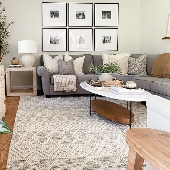 a living room filled with furniture and pictures on the wall above it's coffee table