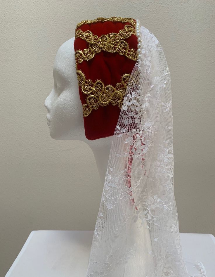 "A new professional quality Renaissance Medieval Elizabethan ladies hat. This cap is a red velvet crown with gold trimming. A row of pearls embellish the back crown with the cascading 21\" lace coverlet. Red ribbon ties hold this regal headpiece in place. New not worn. 16 1/2\" by 3 1/4\". A great item for your reenactment attire, stage production or theme party. Sales final." Medieval Hats Women, Tudor Headpiece, Medieval Veil, Medieval Headpiece, Medieval Headdress, Medieval Headwear, Medieval Fantasy Clothing, Medieval Crown, Medieval Accessories