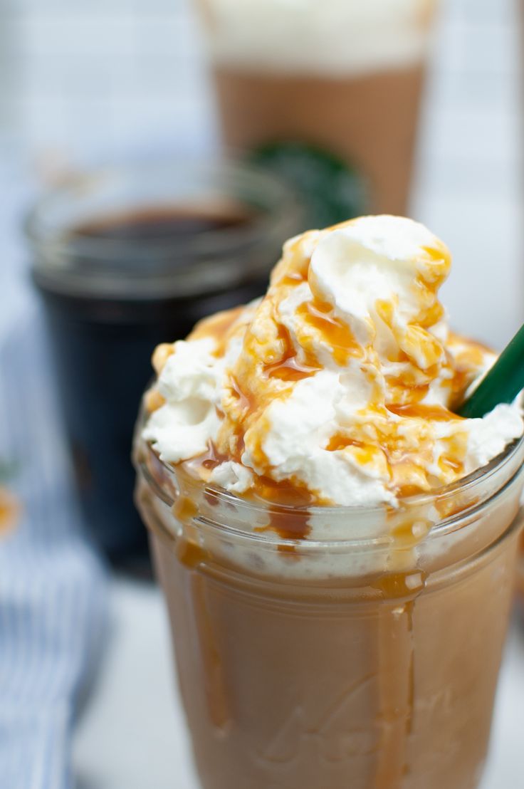 there is a drink with whipped cream and caramel on the top in a mason jar