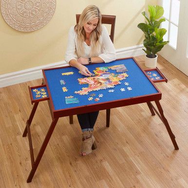 a woman sitting at a table with a puzzle on it