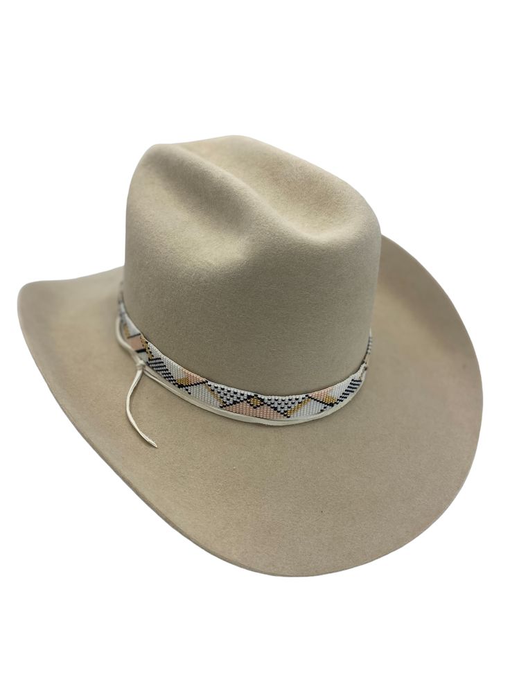 Hand-loomed glass beads Bead-work 19 inches long Sustainably sourced elk leather tie Adjustable sterling silver knot bead allows fit to any hat Shown on western bone colored hat with a western flange, sold separately Artisan Beaded Hat Bands For Western-themed Events, Adjustable Cream Hat Bands For Western-themed Events, Adjustable Cream Hat Band For Ranch, Handmade Western Cream Hat Band, Cream Handmade Western Hat Bands, Handmade Cream Western Hat Bands, Western Beaded Hat Bands For Western-themed Events, Western Beaded Rodeo Hat, Handmade Western Beige Hat Bands