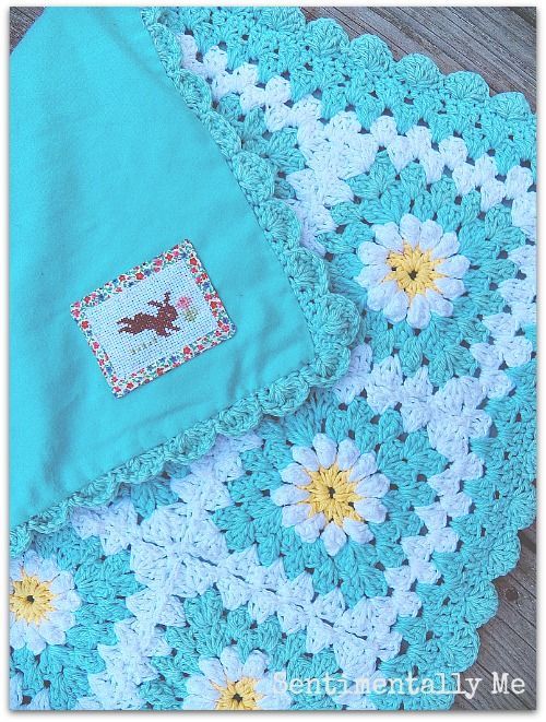 a crocheted blanket with flowers on it