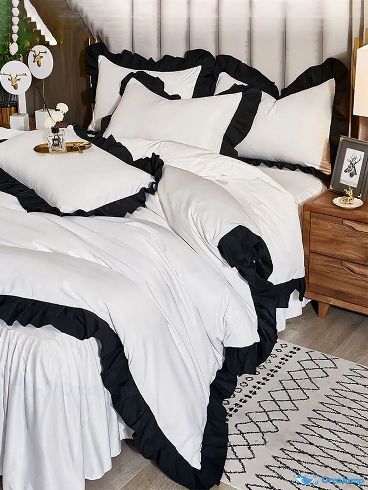 two white and black bedspreads in a bedroom