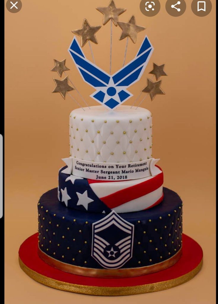 a cake decorated with stars and an air force emblem on top is shown in this image