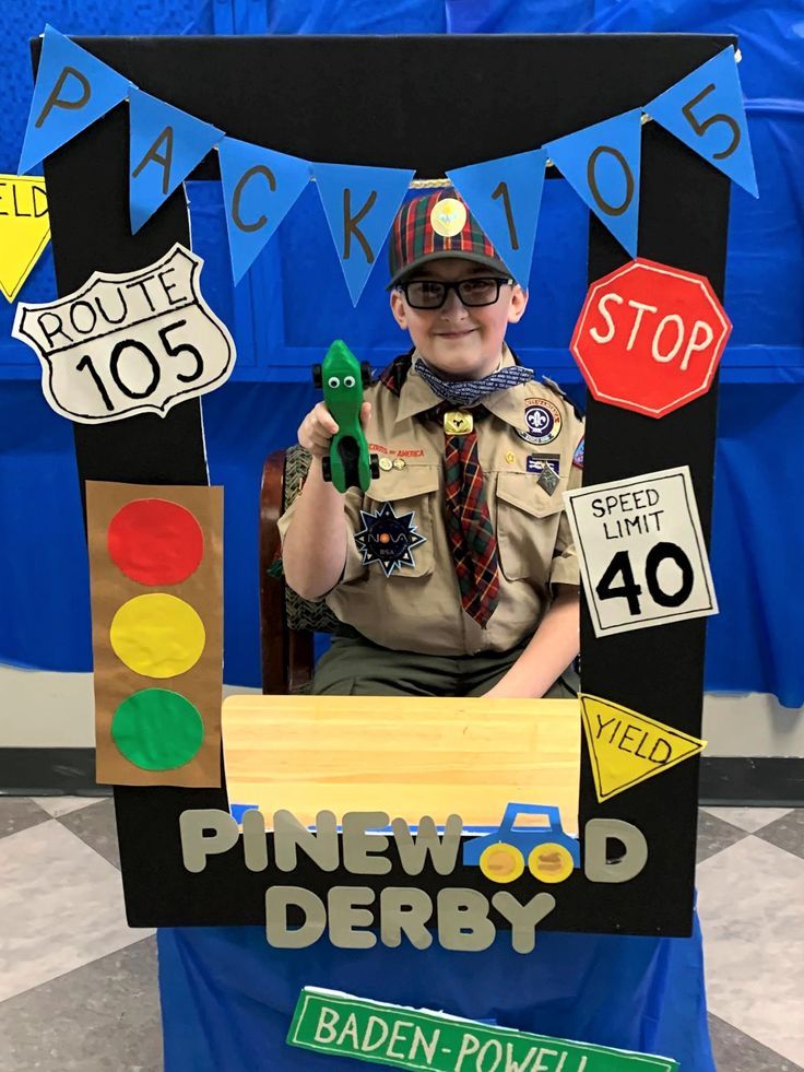 a young boy dressed as a police officer sitting in a chair with traffic signs on it