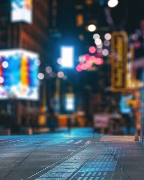 an empty city street at night with blurry lights