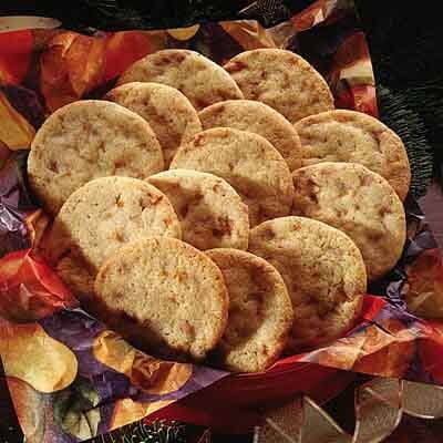 a bunch of heart shaped cookies sitting on top of a table next to christmas decorations