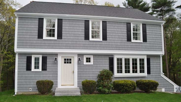 a gray house with black shutters and white trim